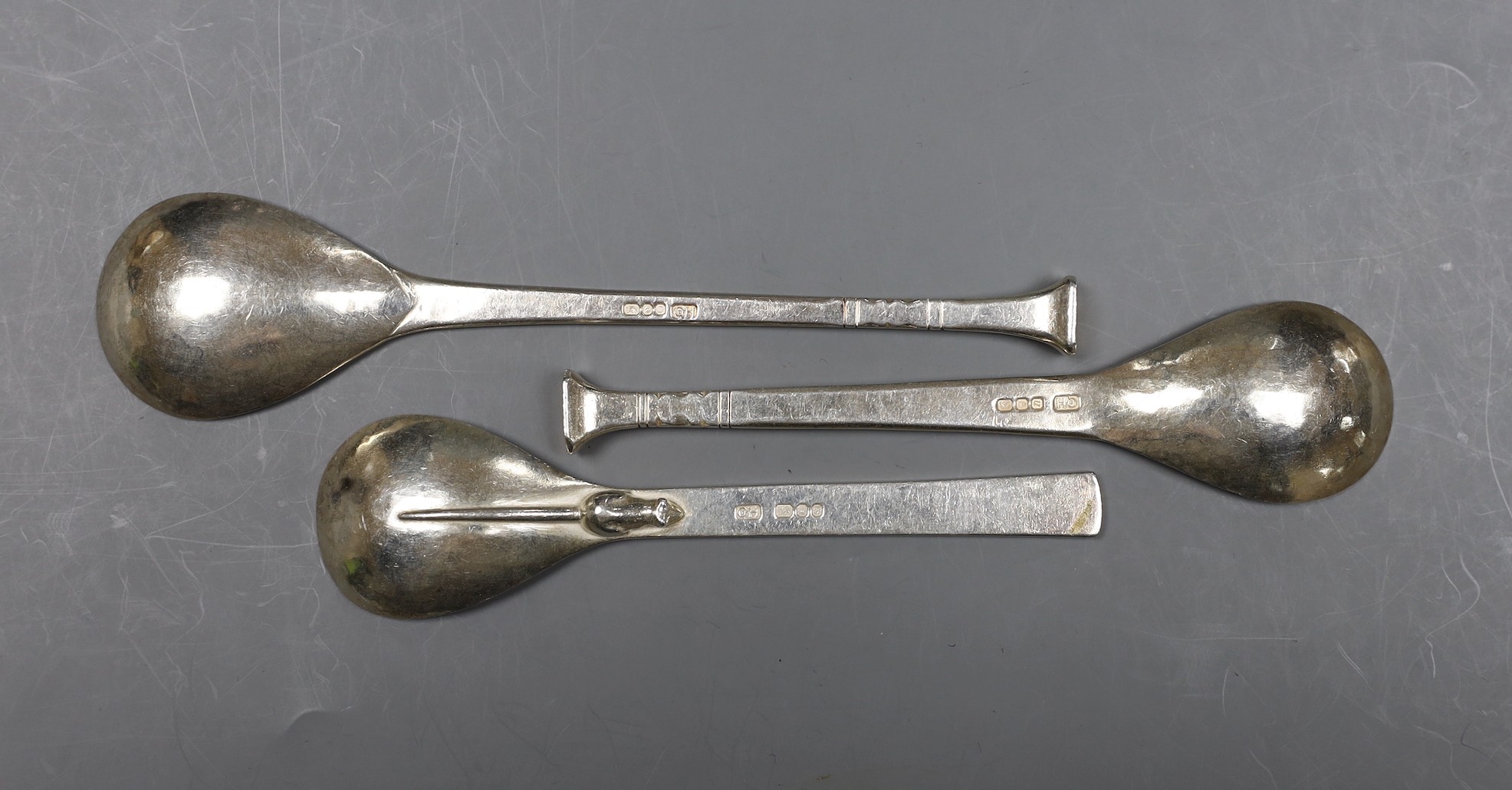 Three assorted modern Art s& Crafts Guild of handcrafts spoons, London, 1968, 1978 & 1980, one with rat on the back of the bowl, longest 17.5cm, 154 grams.